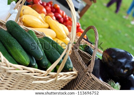Farmer\'s market baskets on a table full with fresh organic produce. Shallow depth of field.