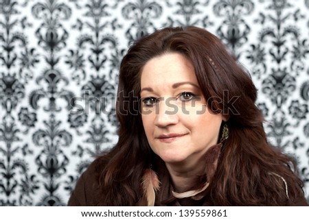 Brunette middle aged woman with feather hair extensions and accessories.
