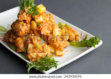 Thai fried calamari appetizer with fresh pineapple chunks.