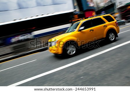 Abstract blur of a speeding taxi SUV truck in New York City.  Slow shutter speed panning technique used for intentional motion blur.