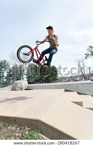 BMX rider athlete spinning his entire bike mid air.  Slight motion blue due to movement.