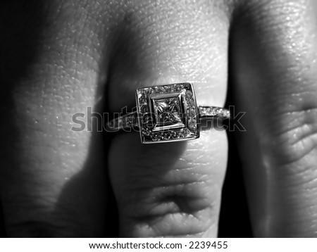 Closeup detail of a custom made princess cut diamond engagement ring.