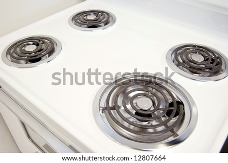 A white electric stove with four burners.
