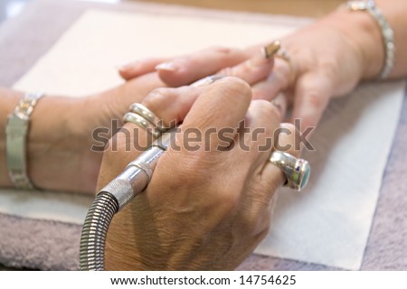 A professional nail technician working on a client\'s nails