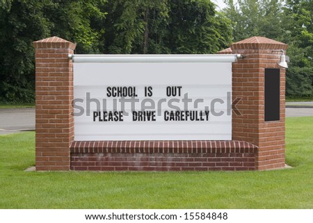A sign on the town green informs drivers to drive carefully since school is out.  Easily add your own message.