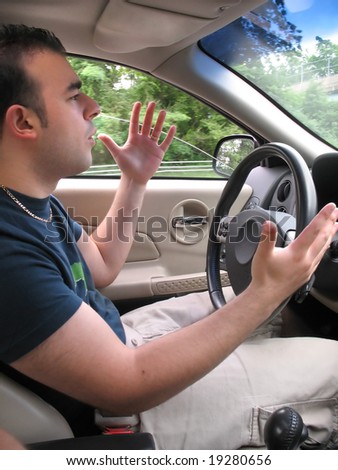 A young man seems to be experiencing some road rage while driving.