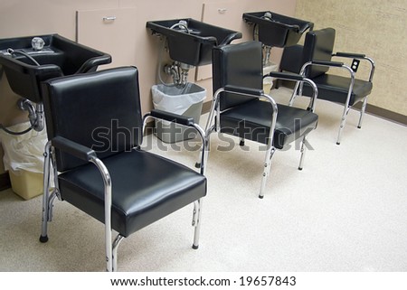 Hair Salon - a row of hair washing sinks and chairs.