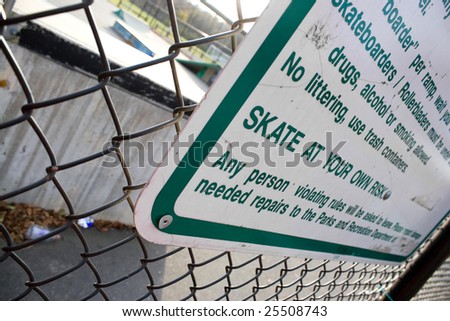 A sign at the skate park clearly states that you will skate at your own risk.  Shallow depth of field.