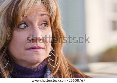 Close up of a pretty middle aged woman looking to the right.