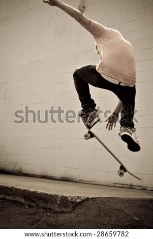 A young skateboarder doing a stunt in an urban area.