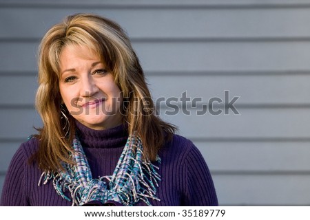 A pretty middle aged woman with a very sincere smile.