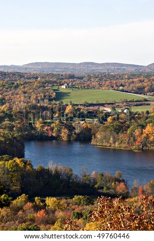 A New England countryside landscape with early autumn foliage at its peak colors.