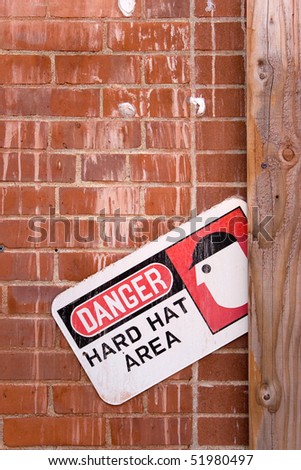 A warning sign that reads DANGER HARD HAT AREA.