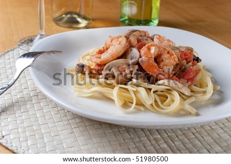 A fresh dish of shrimp scampi over linguine pasta.