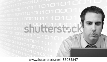 A young business man working from home on his laptop with binary code in the background.  Plenty of copy space.