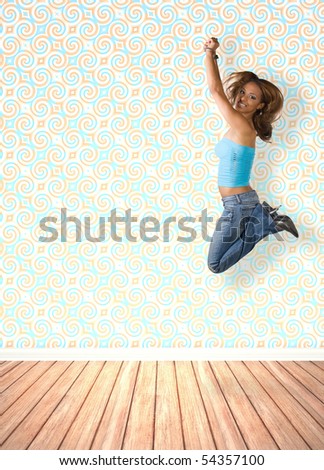 A young woman jumping in the air indoors in front of an interior decorated with vintage wallpaper.