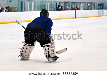 A hockey goalie awaiting the return of the puck so he can resume his defensive role.