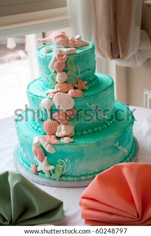 stock photo A blue beach themed wedding cake with three tiers