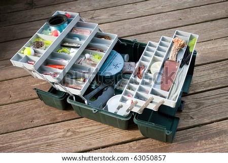 stock-photo-a-large-fisherman-s-tackle-box-fully-stocked-with-lures-and-gear-for-fishing-63050857.jpg