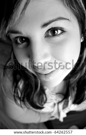 Portrait of an attractive young woman extremely close up in black and white.  Shallow depth of field.