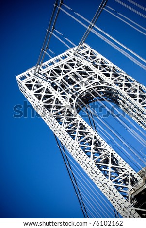A close up portion of the large gate and metal detail on the New York City George Washington Bridge as seen from below.