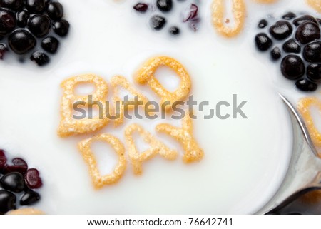 A bowl of alphabet cereal pieces floating in milk with the words BAD DAY spelled out.