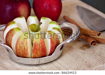 An apple sliced is into wedges and cored using a handy kitchen tool.