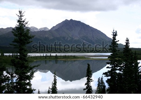 Mountain Reflection. Mountain Reflect in the waters of a kettle lake on the side of Denali Highway. Taken at Denali Highway, Alaska, USA.