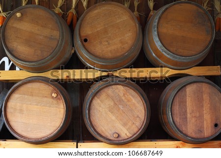 wall of wooden barrels on a rack.
