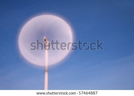 motion blade of modern win turbine in windy day with blue sky.