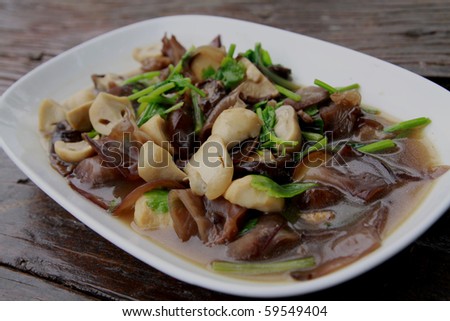 A freshly cooked mushroom stir fry served in a white dish