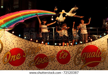 SYDNEY, AUSTRALIA - MARCH 5: Some women dance on the big car at parade on March 5, 2011 for Mardi Gras in Oxford Street, Sydney, Australia. Mardi gras is an annual event for gay/lesbian acceptance.