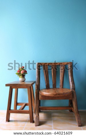 interior design of wood chair on a blue wall.