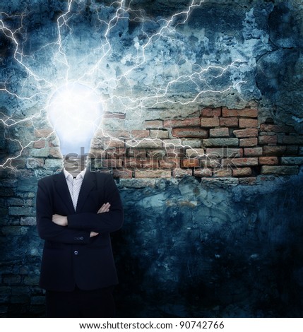 Businessman idea head bulb symbol with lightning flash strike on break wall