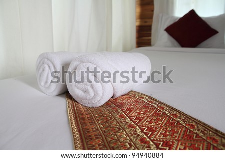 soft white towels, rolled and piled