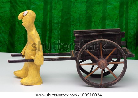 stock photo : Cartoon plasticine character with an empty hand cart