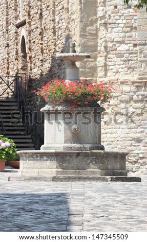 medieval fountain in the old town of San Leo, Italy