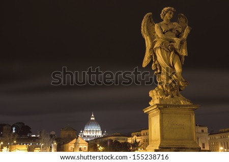 Angel statue over the Vatican City at night