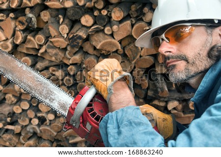 lumberjack close up with chainsaw, forest worker in action