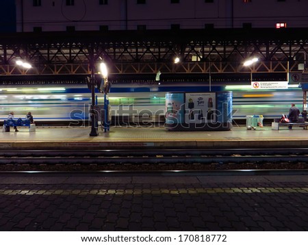 ROME, ITALY - DECEMBER 2:commuters wait on platform in Trastevere station as a train slow down at early morning on December 2, 2013 in Rome Italy.