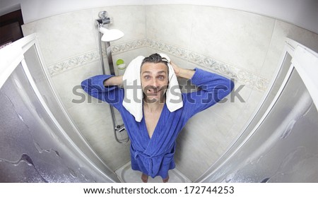 smiling man in bathrobe after shower