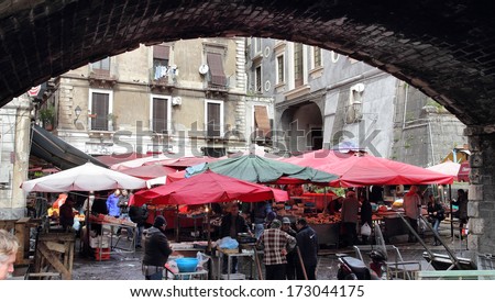 CATANIA, ITALY - FEBRUARY 28, 2012: costumers and sellers in the historical Fish Market in the crowded square Alonzo di Benedetto. This market has a history of several centuries