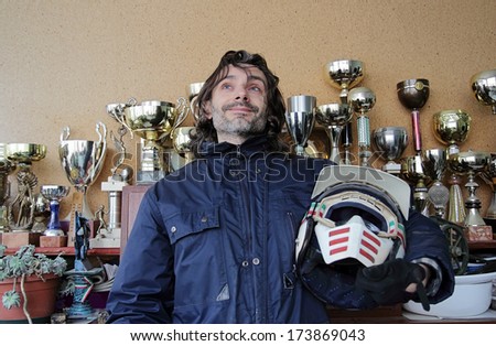 champion pose with helmet over a victory cup background
