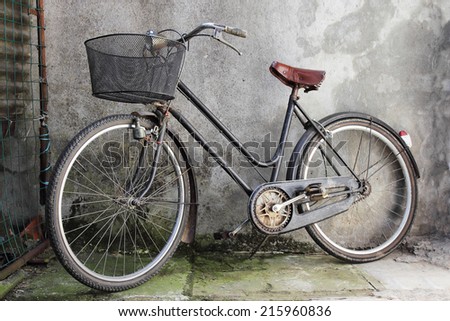 old bicycle over a shabby background