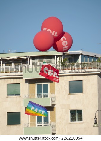 ROME, ITALY - OCTOBER 25, 2014: Flags and balloons of CGIL labor union waving on San Giovanni square