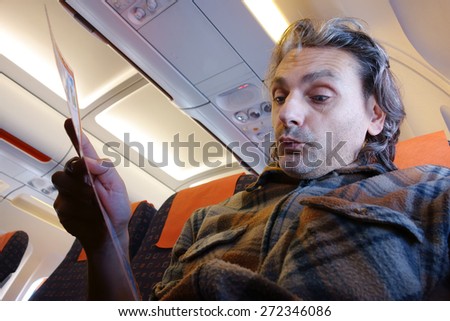 man on board reading Flight Rules and Safety Precautions
