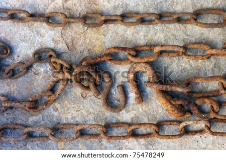 rusty chain with hook over stone background
