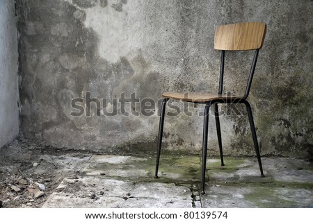 grunge shabby interior with a simple single chair