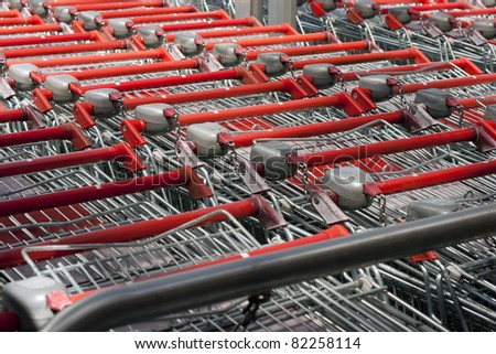 red shopping carts in a row, close up