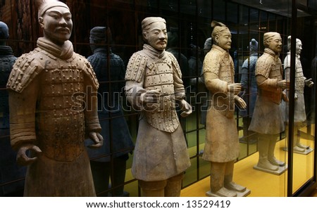 Sculptural group of the Chinese soldiers of an antiquity on a background of a glass wall